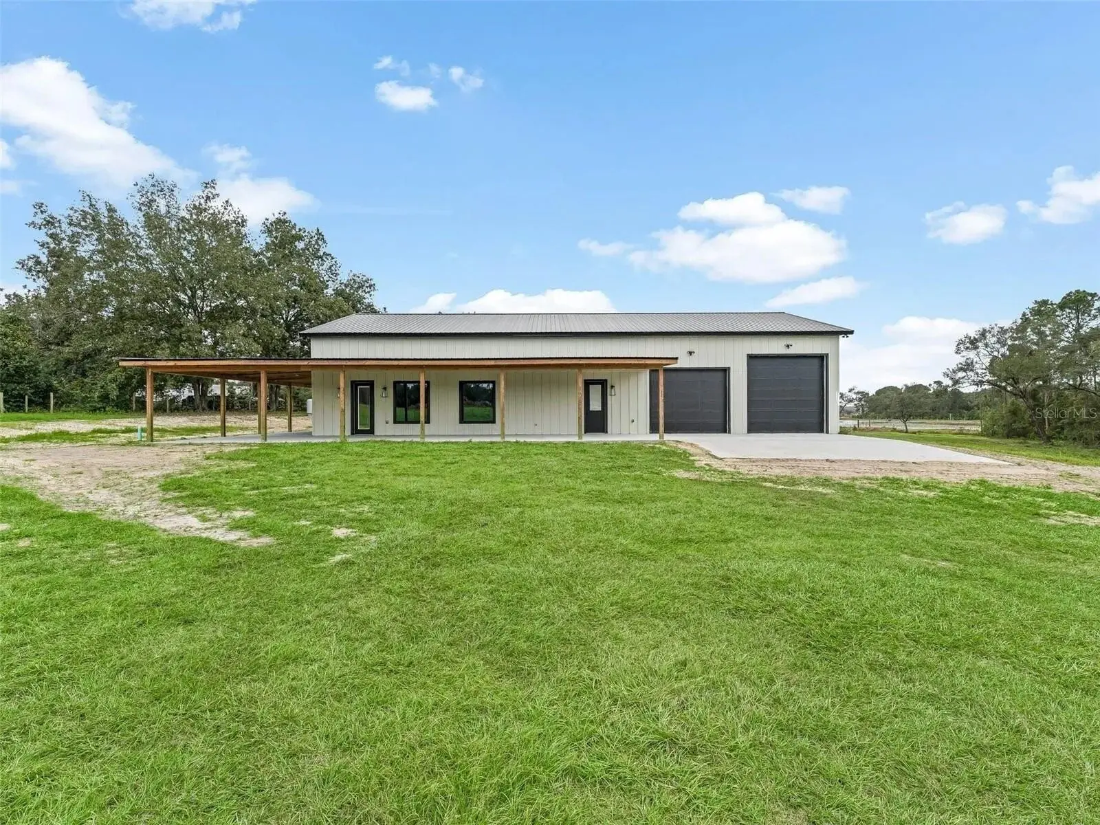 Metal-roofed barn with a wraparound porch in Marion County, FL