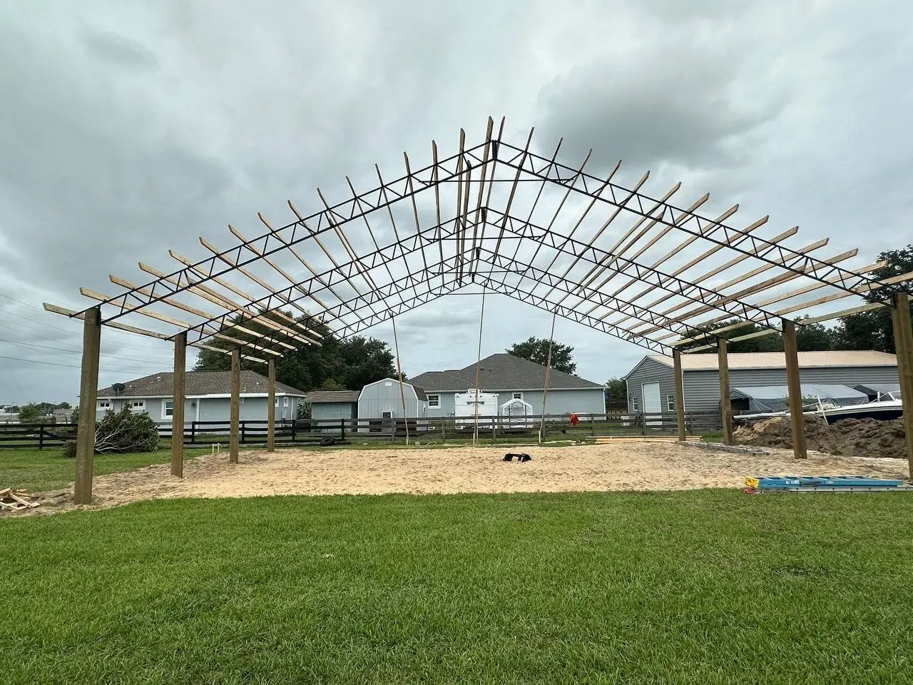 Steel roof trusses being set on a pole barn in Central Florida